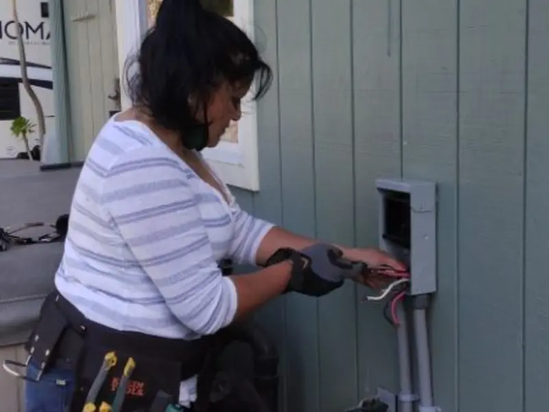 Licensed electrician wiring an exterior subpanel in Tysons